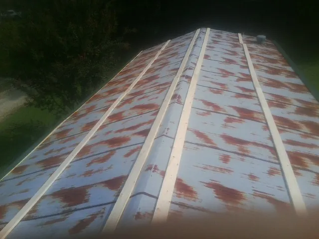Rusted metal roof panels with new wood purlins before replacement — Storm Damage Roof Repair in Boling by Roofing Brothers